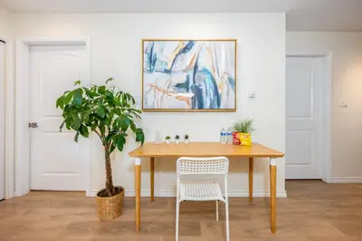 a dining room with a table and a potted plant at Central Van 3BR Upper Suite - Near Skytrain in Vancouver