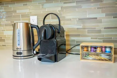 a counter top with a coffee maker and a tea kettle at Central Van 3BR Upper Suite - Near Skytrain in Vancouver