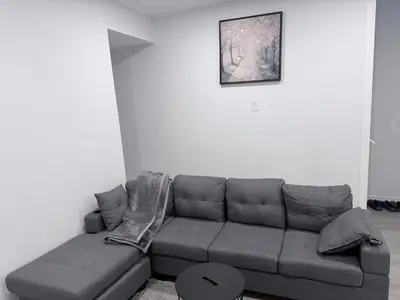 a living room with a couch and a picture on the wall at The Cozy Spot in Edmonton