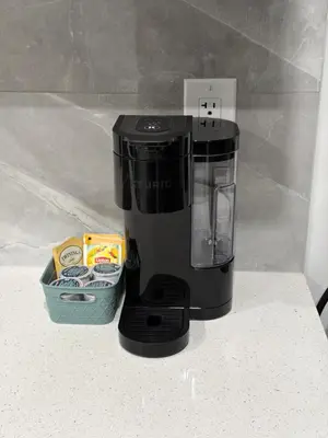 a black blender sitting on a counter next to a container at The Cozy Spot in Edmonton