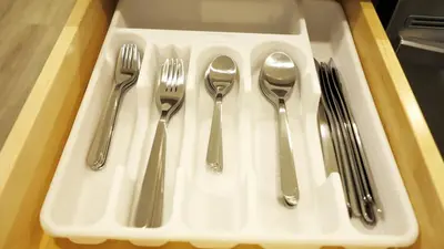 a tray with utensils sitting on a table at A Touch of the Tropics-Cozy Warm 2BR Stay in Edmonton