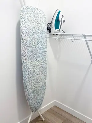a mirror on a stand next to a wall at A Touch of the Tropics-Cozy Warm 2BR Stay in Edmonton