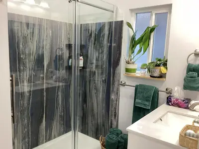 a bathroom with a shower and a sink at The Cozy Nook in Grand Forks