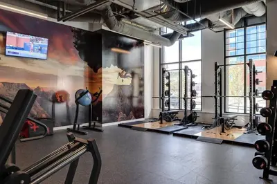 a gym with treadmills and machines in a room at Simple Minimalist Condo For Busy Students or Professionals in Calgary