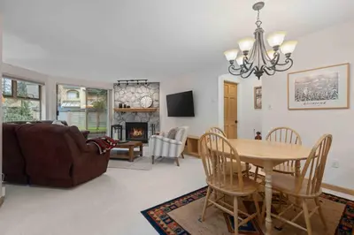 a living room with a table and a couch at Glen Eagles by Whistler Premier in Whistler