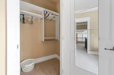 a walk in closet with a mirror and a hallway at Cozy Private Space in Richmond with Modern Comforts in Richmond
