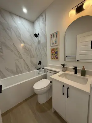 a white bathroom with a toilet and a sink at Private 2BR Lake Suite - Chestermere - Sleeps 6 in Chestermere