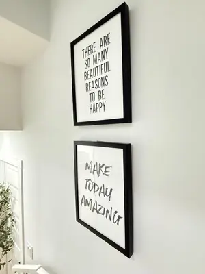 two framed posters on a white wall in a room at Private 2BR Lake Suite - Chestermere - Sleeps 6 in Chestermere