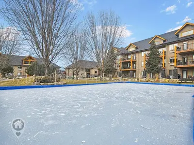 an ice hockey rink in front of a building at Bighorn Meadows Condos by StayIn in Radium Hot Springs