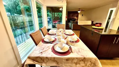 a dining room table with plates and dishes on it at Emerald 3Bed 1bath Rancher 2C-D EvEs Spa BBQ RKE in Langley