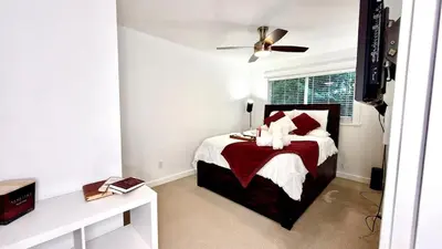 a bedroom with a bed with red and white pillows at Emerald 3Bed 1bath Rancher 2C-D EvEs Spa BBQ RKE in Langley