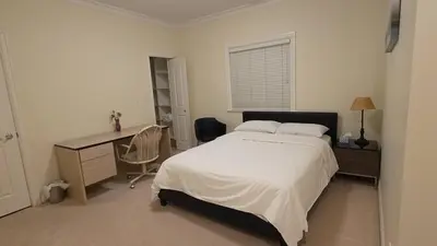 a bedroom with a bed and a desk and a desk at Vancouver Richmond Villa47 in Vancouver