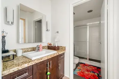 a bathroom with a sink and a toilet and a mirror at Central Vancouver 1BR Close to Transit in Vancouver