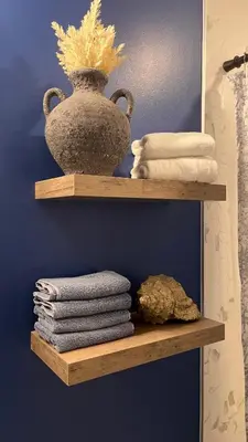 a shelf with towels and a vase on it at Modern & Stylish Condo in Langley City in Langley