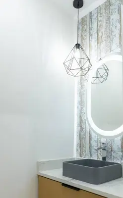 a bathroom with a sink and a mirror at Elegant Stylish Modern Residence in Vancouver