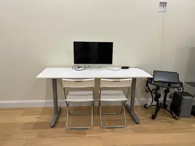 a white table with two chairs and a computer on it at SixPine - New 2Br Suite in Vancouver