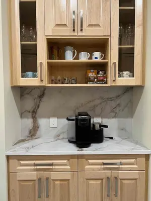 a kitchen with wooden cabinets and a coffee maker on a counter at SixPine - New 2Br Suite in Vancouver