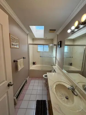 a bathroom with a sink and a shower and a tub at Cozy Private Queen room Scott Rd in Bélanger