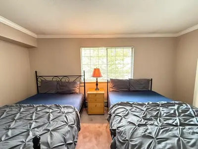 a bedroom with two beds and a window at Cozy Private Queen room Scott Rd in Bélanger