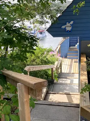 a wooden bench in front of a blue building at See Aurora and lake from EVERY room - 2bd 2bth in Yellowknife