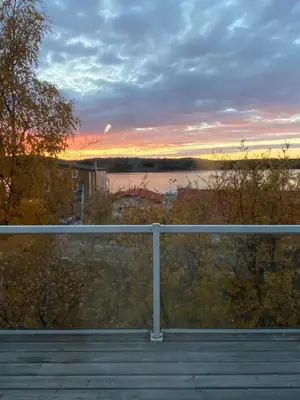 a view of a sunset from a balcony at Aurora views from 2 br apartment by lake in Yellowknife