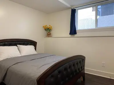 a bedroom with a large bed with a window at Modern 2BR Retreat Near West Edmonton Mall in Edmonton