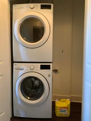 a dryer and a washing machine in a room at Modern 2BR Retreat Near West Edmonton Mall in Edmonton