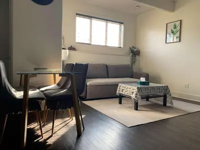 a living room with a couch and a table at Modern 2BR Retreat Near West Edmonton Mall in Edmonton