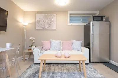 a living room with a couch and a table at Modern 2BR Suite | 10 Mins to YVR & Canada Line in Vancouver