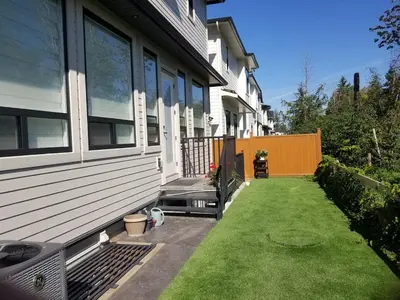 a backyard of a house with a grass yard at BRAND NEW LUXURY 4 Beds 4 baths Home Langley Perfect for Families and Groups in Langley