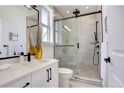 a white bathroom with a shower and a toilet at BRAND NEW LUXURY 4 Beds 4 baths Home Langley Perfect for Families and Groups in Langley