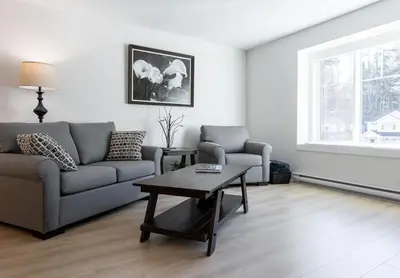 a living room with a couch and a coffee table at Cozy Corner on Trumpeter in Colwood