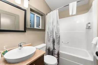 a bathroom with a sink and a toilet and a shower at JDF Waystation with Bunkhouse - Pet Friendly - sleeps 6 in Port Renfrew