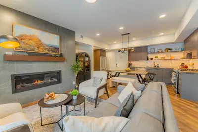 a living room with a couch and a fireplace at Brand New Canmore Condo by Canadian Rockies Vacation Rentals in Canmore