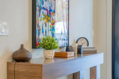 a table with a potted plant on top of it at Brand New Canmore Condo by Canadian Rockies Vacation Rentals in Canmore