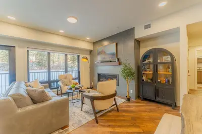 a living room with a couch and a fireplace at Brand New Canmore Condo by Canadian Rockies Vacation Rentals in Canmore