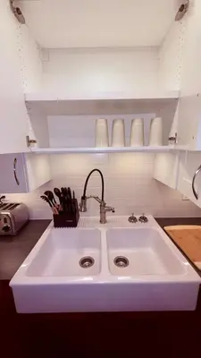 a white sink in a kitchen with a counter at Fields & Fences Suite in Maple Ridge District Municipality