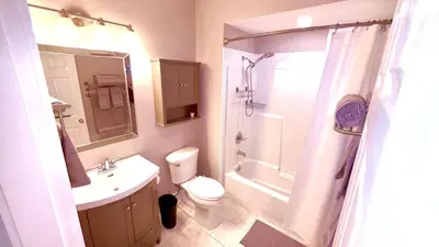 a bathroom with a sink and a toilet and a shower at Fields & Fences Suite in Maple Ridge District Municipality