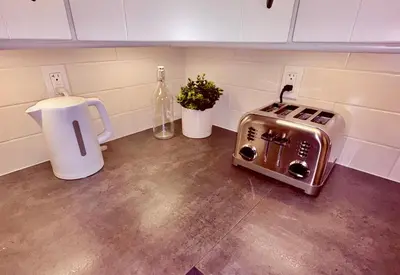 a toaster sitting on the floor in a kitchen at Fields & Fences Suite in Maple Ridge District Municipality