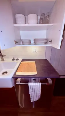a kitchen with a counter top with plates and dishes at Fields & Fences Suite in Maple Ridge District Municipality