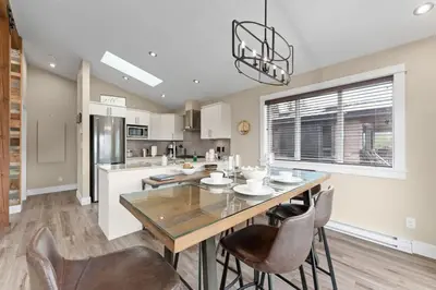 a kitchen with a dining room table and chairs at Wild Beauty - Oceanview - Pet Friendly - sleep 2 in Port Renfrew