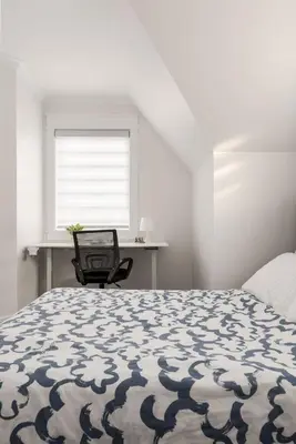 a bedroom with a bed and a desk and a window at Family friendly Lux house Near University Train Hospital in Edmonton