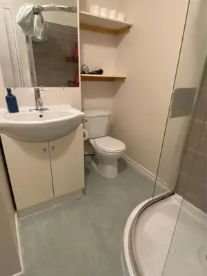 a bathroom with a toilet and a sink and a shower at Queen bedroom suite with private bathroom and independent entrance in Kelowna