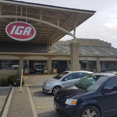 a kia dealership with cars parked in a parking lot at Queen bedroom suite with private bathroom and independent entrance in Kelowna