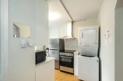 a kitchen with a stove and a microwave at Quiet & Walkable - Stampede, BMO, Nightlife & Eats in Calgary