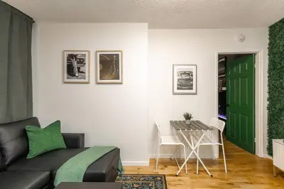 a living room with a couch and a table at Quiet & Walkable - Stampede, BMO, Nightlife & Eats in Calgary