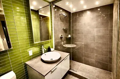 a bathroom with a shower and a sink and a toilet at Pacific Pearl in Vancouver