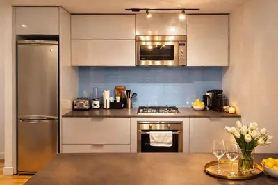 a kitchen with stainless steel appliances and a counter top at Pacific Pearl in Vancouver