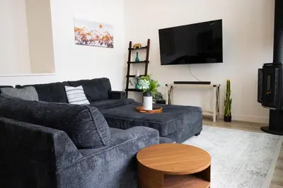 a living room with two couches and a flat screen tv at Ultimate Family Retreat Beach, Hot Tub & Games in Windermere