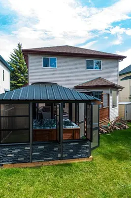 a gazebo in the yard of a house at Family Retreat Hot Tub Banff and Calgary DT Access in Calgary